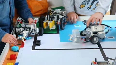 Several kids testing their computerized robots on special table. Editorial Video stock 87040659