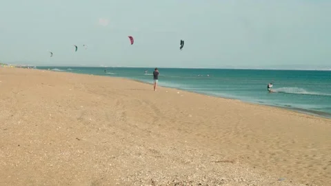 Several kiters practise kiting in the sea on sindy summer afternoon. Summer Stock-Footage 139871042