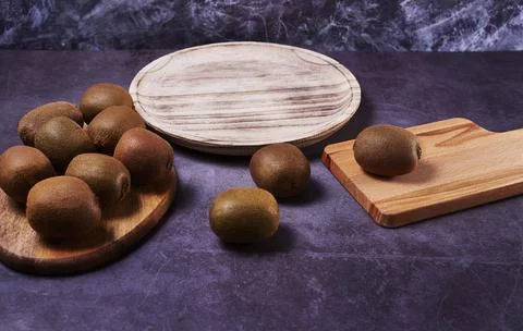 Several kiwis on wooden elements Stock Photos