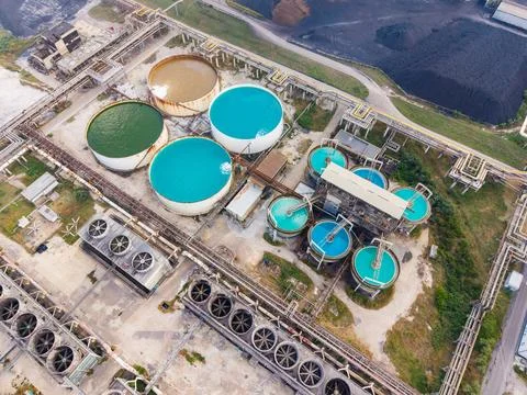 Several large circular tanks filled with different colored water are seen at  Stock Photos