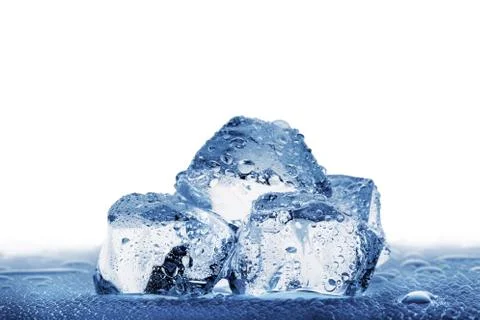 Several large ice cubes with droplets on wet table Stock Photos