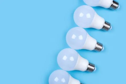 Several LED bulb on blue background. Saving energy concept. Stock Photos