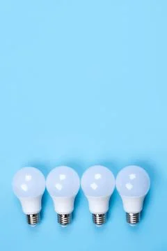 Several LED bulb on blue background. Saving energy concept. Stock Photos