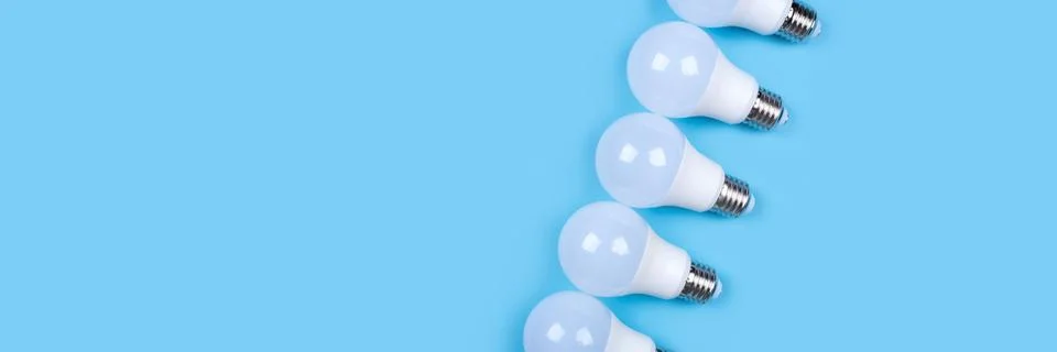 Several LED bulb on blue background. Saving energy concept. Stock Photos