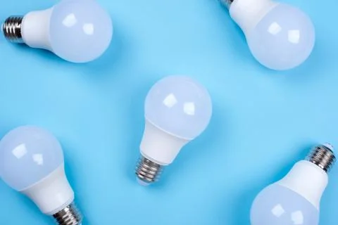 Several LED bulb on blue background. Saving energy concept. Stock Photos