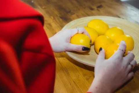 Several lemons on a plate, on a kitchen table Stock Photos