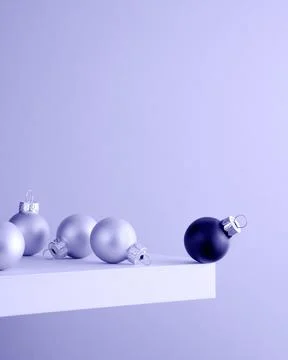 Several light and one black Christmas ball on the shelf at the edge of the cl Stock Photos