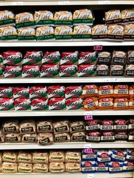 Several loaves of bread on a store shelf Stock Photos