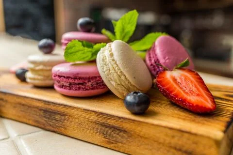 Several macaroons on desk decorated Stock Photos
