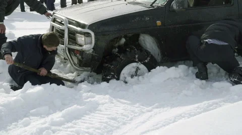 Several men dig the car stuck in the snow Video stock 61378343