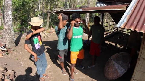 Several men share eclipse viewing glasses to look at the sun in Indonesia. Stock Footage 114716678