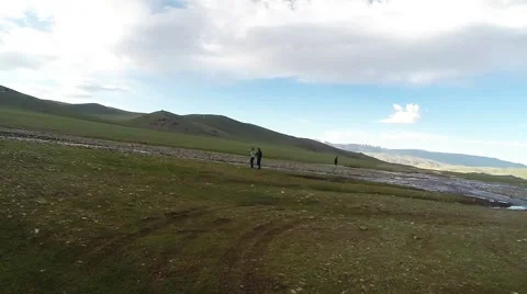 Several Men Walking Around River Bank in Highland Stock Footage 60582628