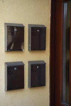 Several metal mailboxes for correspondence on light wall Stock Photos