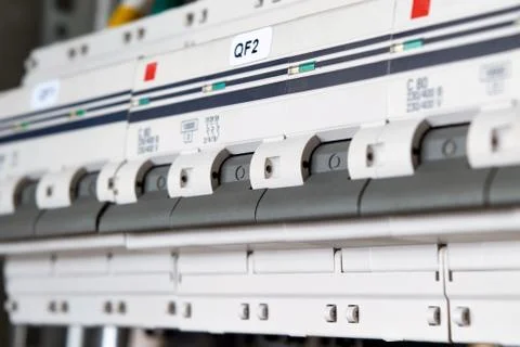 Several modular circuit breakers are located in a range in an electric Cabine Stock Photos
