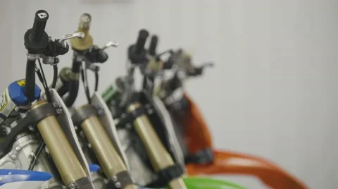 Several motorcycle in the garage - handlebars of enduro cross motorbike Stock Footage