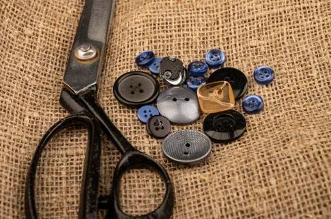 Several multi-colored buttons of different sizes and large vintage sartorial  Stock Photos