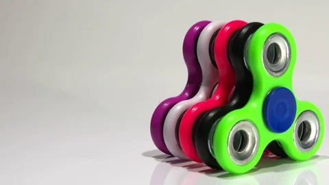 Several multi-colored spinners on the table Stock Footage 77734641