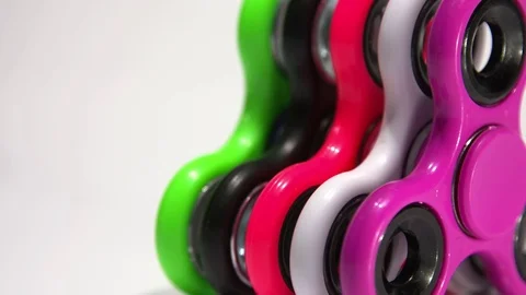 Several multi-colored spinners on the table Stock Footage 77734815