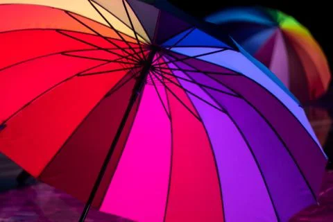 Several multi-colored umbrellas on stage during a concert. Foto stock
