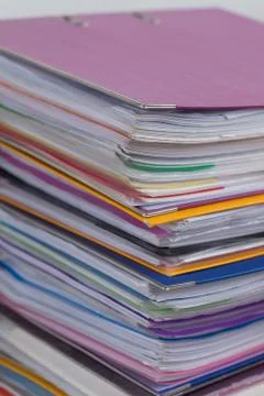 Several multicolored folders with documents stacked in a pile on Stock Photos