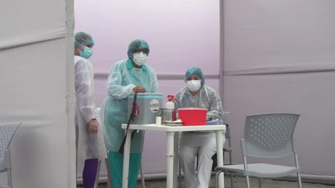 Several nurses in their premises separated by awnings waiting for patients to be Video stock 156307182