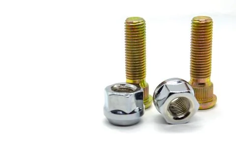 Several nuts and studs for installing the wheel on the car Stock Photos
