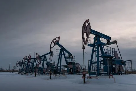Several Oil pumpjack winter work is the overground drive for a reciprocating  Foto stock