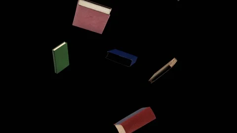 Several old books are chaotically moving around and circling on a black Stock Footage 155664742