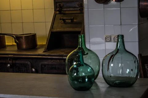Several old bottles in a rustic kitchen Stock Photos