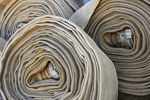Several old rolled fire hoses Stock Photos
