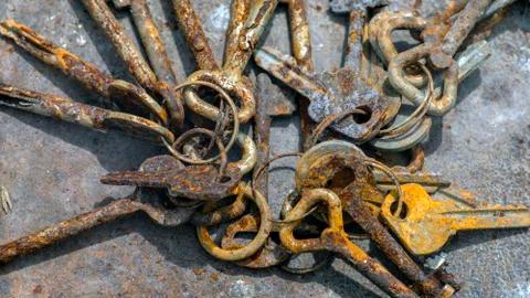 Several old rusty keys on ring shot on textured background Stock Photos