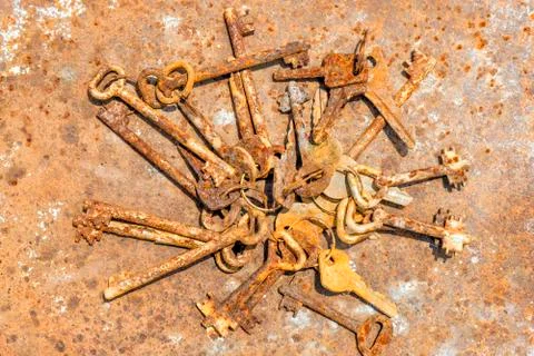 Several old rusty keys on ring shot on steel textured background Stock Photos
