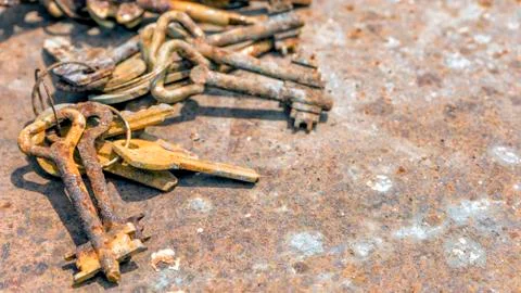 Several old rusty keys on ring shot on steel textured background Stock Photos