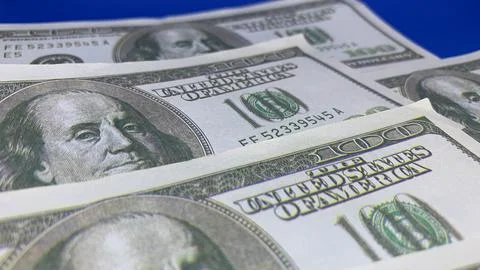 Several one-hundred-dollar banknotes arranged in layers, Stock Photos