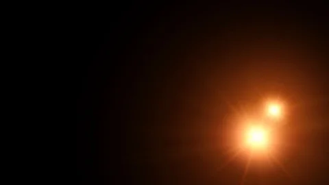 Several orange shining lights moving from right to left on black background in Stock Footage 115698019