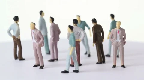 Several painted toy men stand and drop shadows Stock Footage 8520045