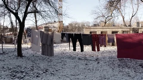 Several Pairs of Clothes Drying Near The House in Winter Stock Footage 59758693