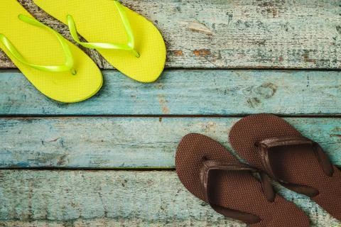 Several pairs of multi-colored rubber flip-flops exhibited in a Stock Photos