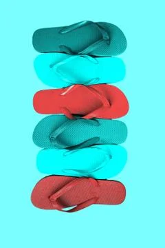 Several pairs of multi-colored rubber flip-flops exhibited in a row, isolated Stock Photos