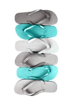 Several pairs of multi-colored rubber flip-flops exhibited in a row, isolated Stock Photos
