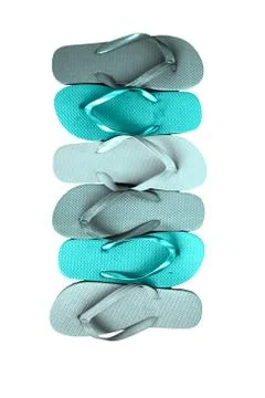 Several pairs of multi-colored rubber flip-flops exhibited in a row, isolated Stock Photos