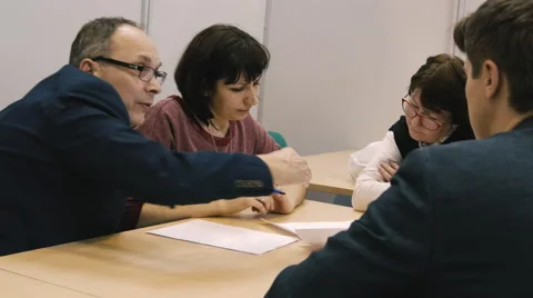 Several people are talking at the table Stock Footage 61539386