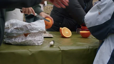 Several people cutting oranges on a table Stock Footage 168182305