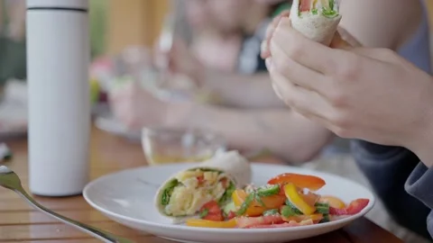 Several people eat at a large table, outdoor breakfast, salad close-up Stock Footage 208907541
