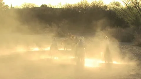 Several People On Horseback Behind A Cloud Of Dust Video stock 19309716