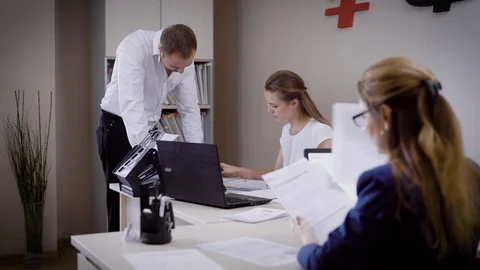Several people look at the documents in the office, the man and the woman work Video stock 82718551