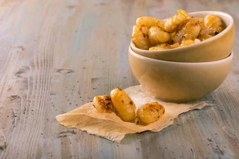 Several pieces of gnocchi in front of portion in two bowls Stock Photos