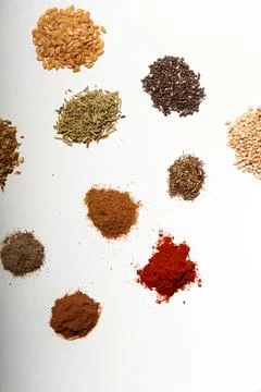 Several piles of aromatic spices of different colors Stock Photos