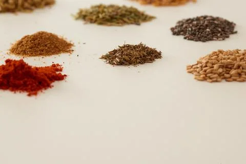 Several piles of aromatic spices of different colors Stock Photos