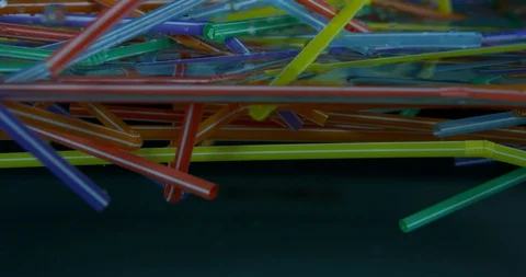 Several Plastic Colourful Straws Floating Around In The Sea. Plastic Pollution  Stock Footage 111937269